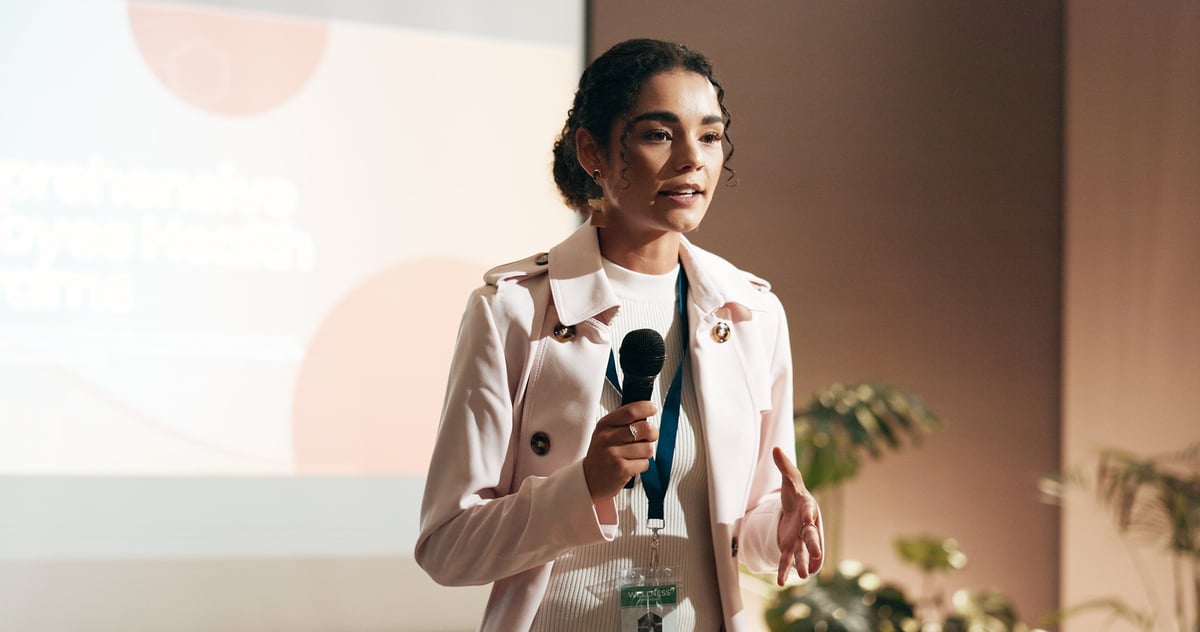 Business woman, conference and presentation for speaker in seminar room for wellness training