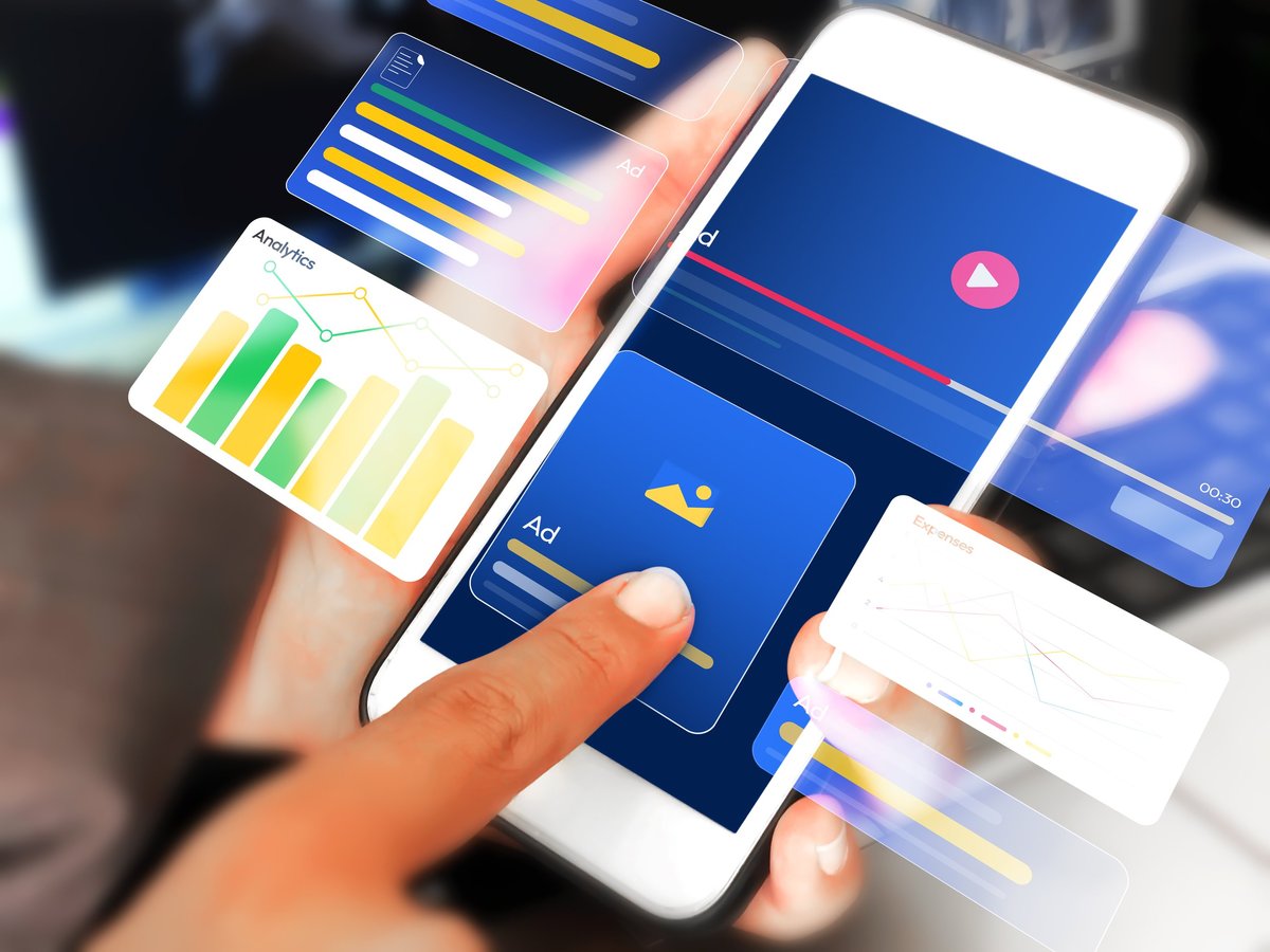 Advertisement and marketing through mobile phone concept with hovering analytics and ads design. Person touching the screen and showing ads