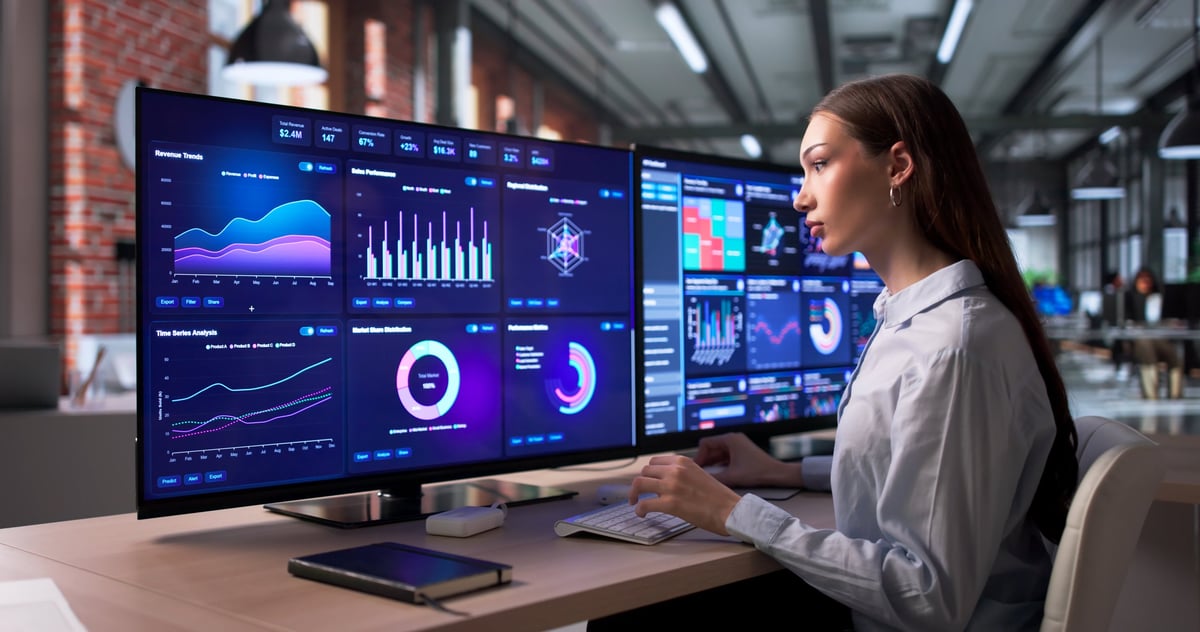 Woman Focused On Computer Screen Analyzing Business Data Dashboard Metrics.
