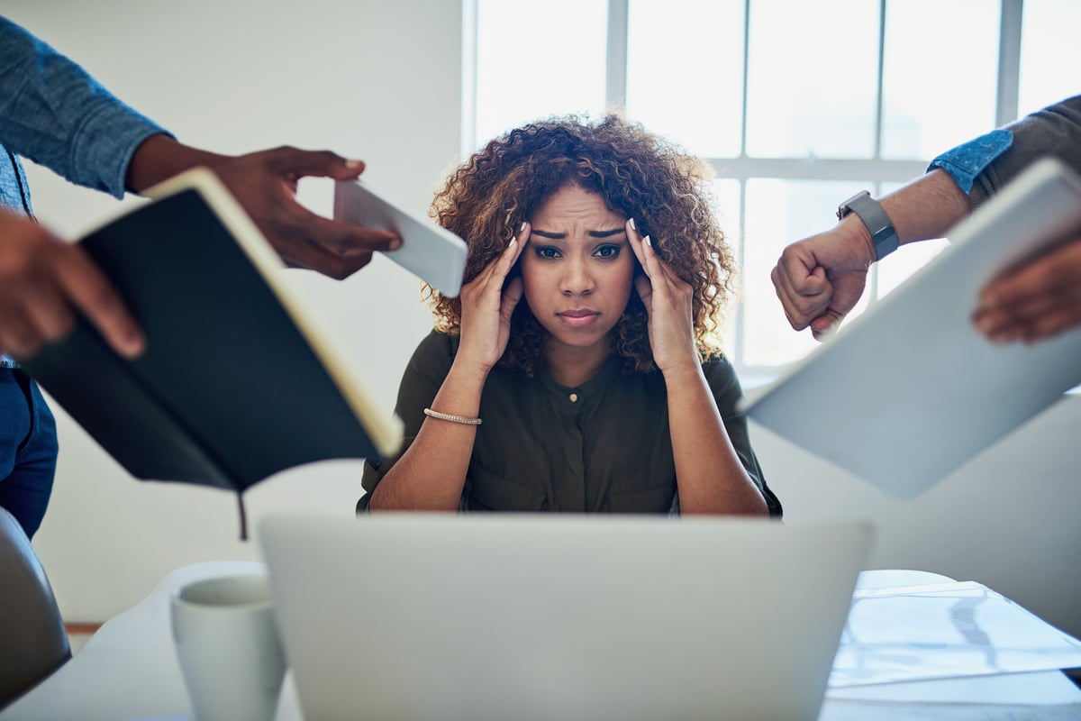 Shot of a stressed out young woman working in a demanding career