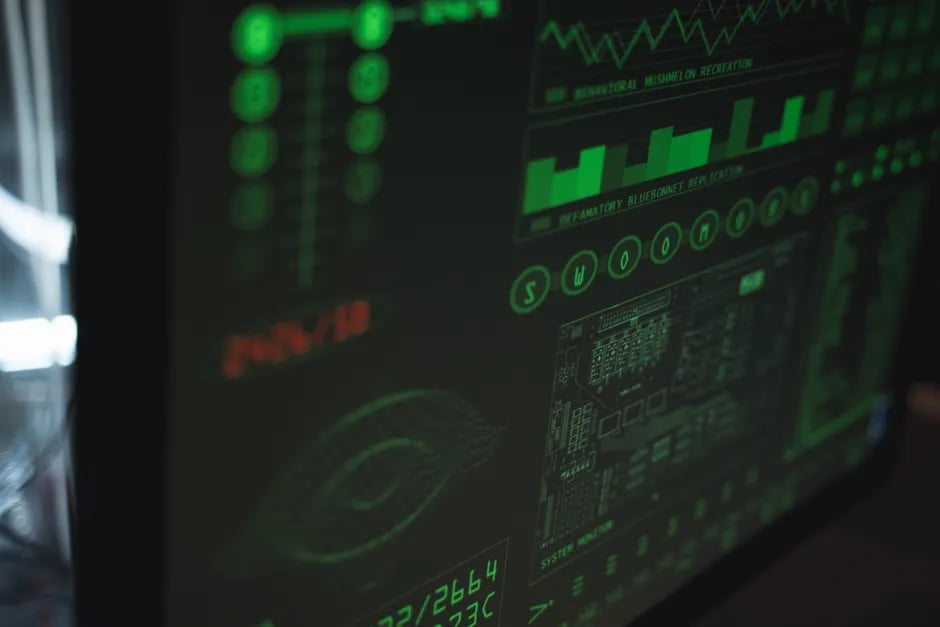 Computer monitor displaying green technical data and graphs with red error text on black background